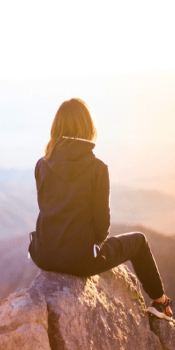 woman sitting on a rock